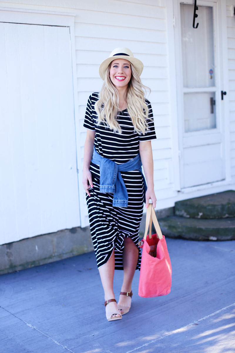 Fresh-faced and beautiful, Abby wears a striped dress, wicker hat, and denim jacket tied around her waist.