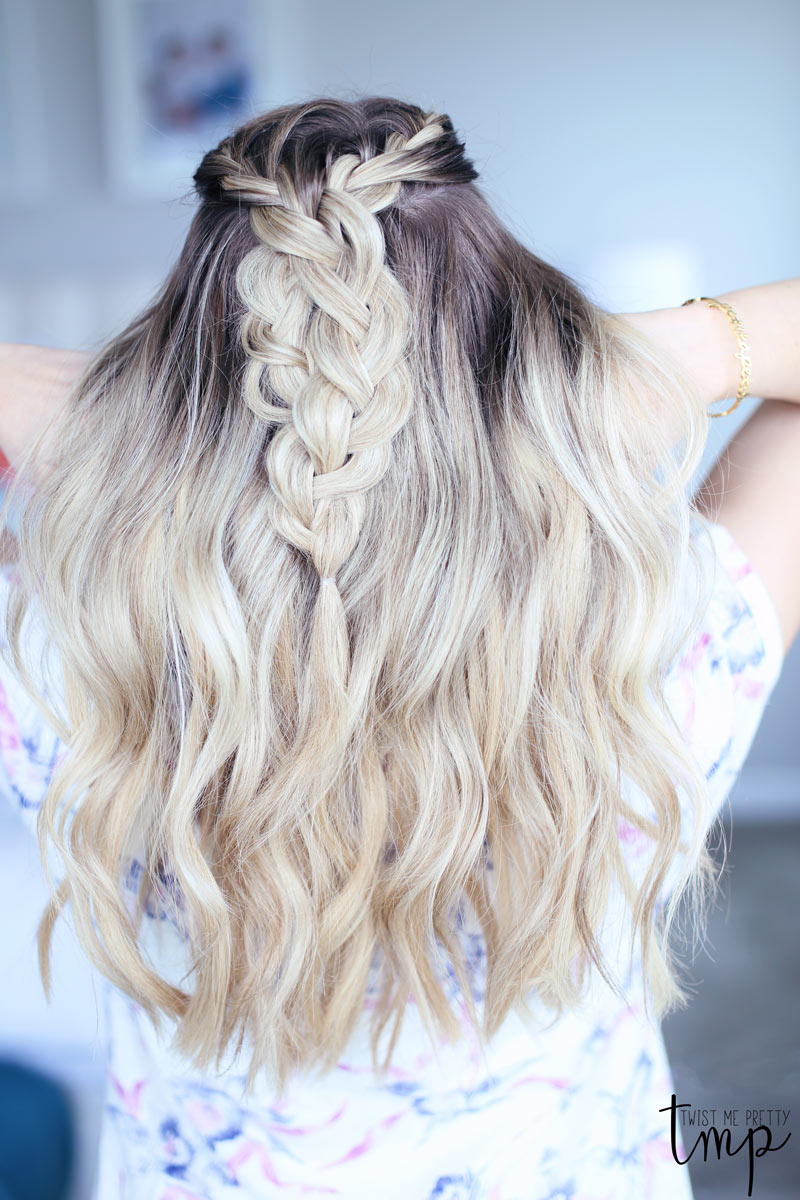 Wavy hair frames Abby's braids.