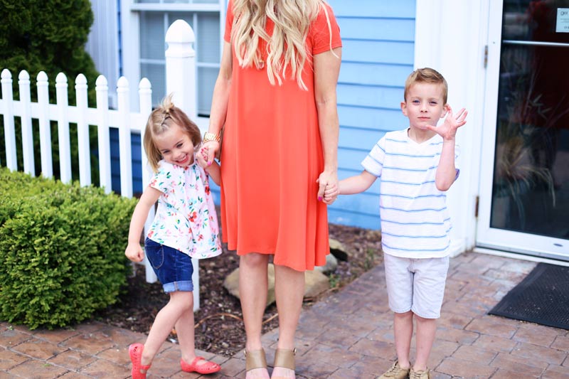 Savy and Boston pose as they hold their mother's hands